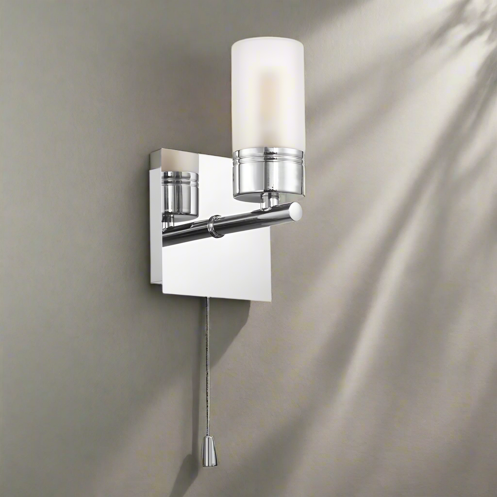 Chrome wall sconce with glass shade on a white background