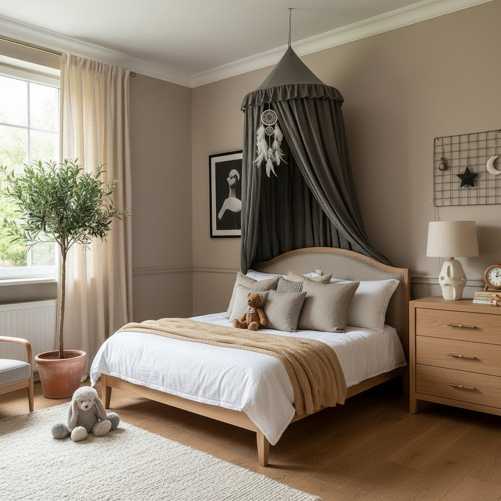 A styled children's bedroom featuring a light wood bed with white bedding, a dark gray canopy with a dreamcatcher, beige walls, a wooden nightstand, and a potted plant by a window.