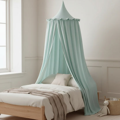 A light mint green canopy bed net hanging over a wooden bed in a bright, neutral-toned bedroom.