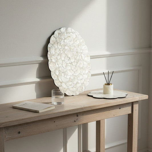 Wooden console table with decorative items against a white wall