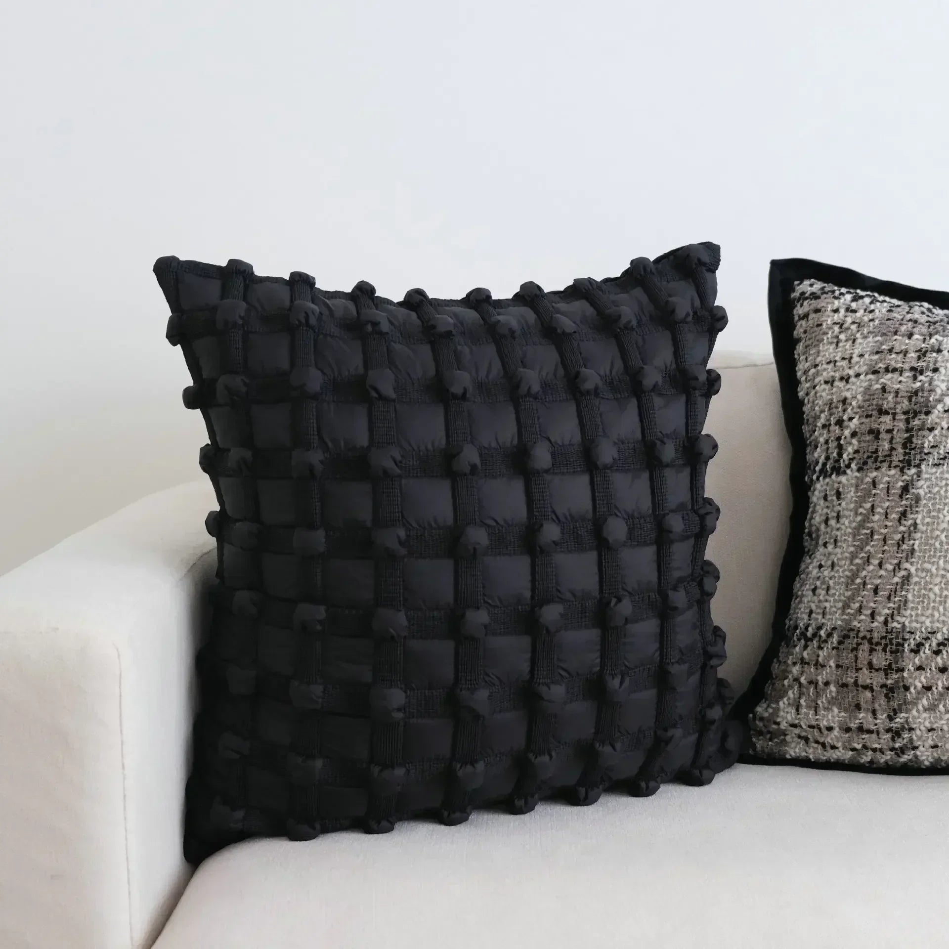 Black pom pom cushion hotsell