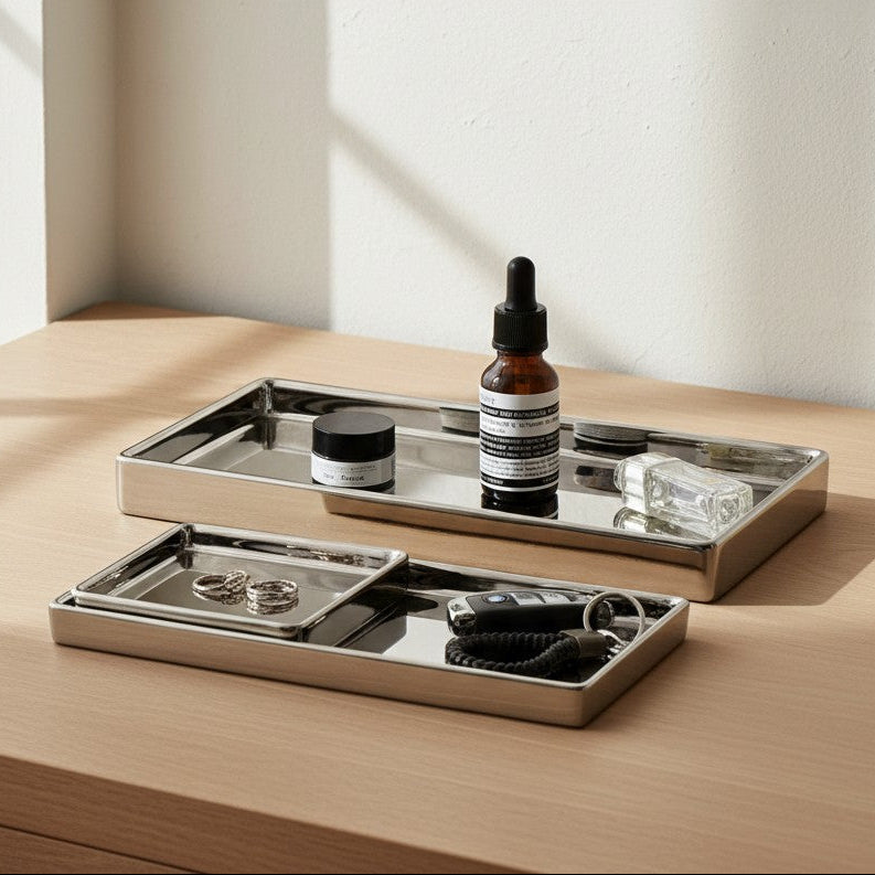 Bottle of Aesop product on a mirrored tray with a neutral background