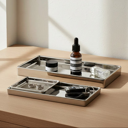 Bottle of Aesop product on a mirrored tray with a neutral background