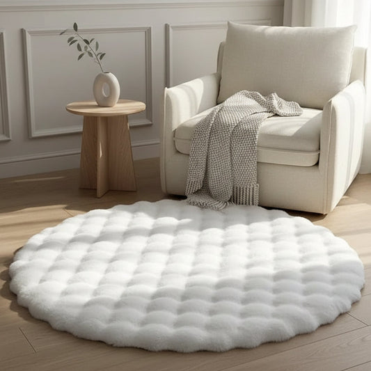 Round white rug on a wooden floor with a beige armchair and side table in the background.
