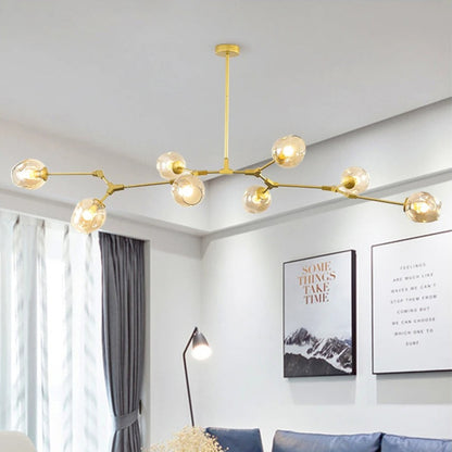 Modern living room with a gold chandelier, blue sofa, and decorative elements.